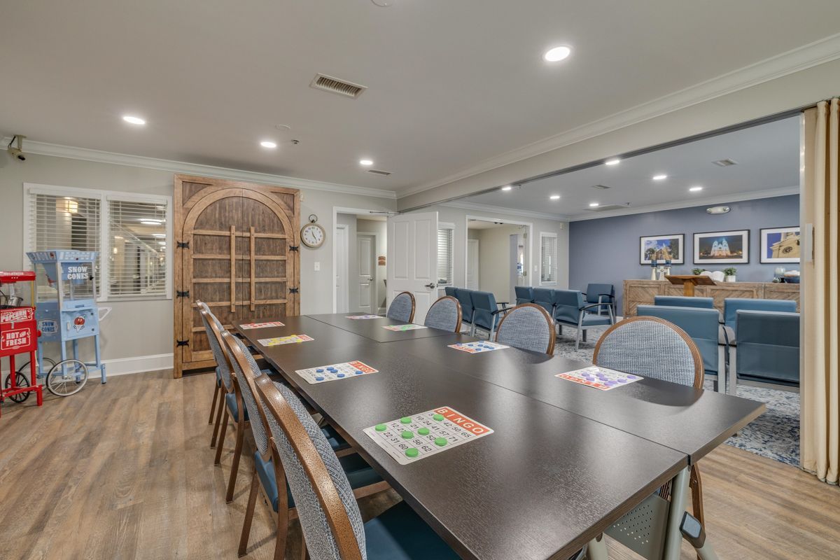 There is a long table and chairs in the middle of the room.