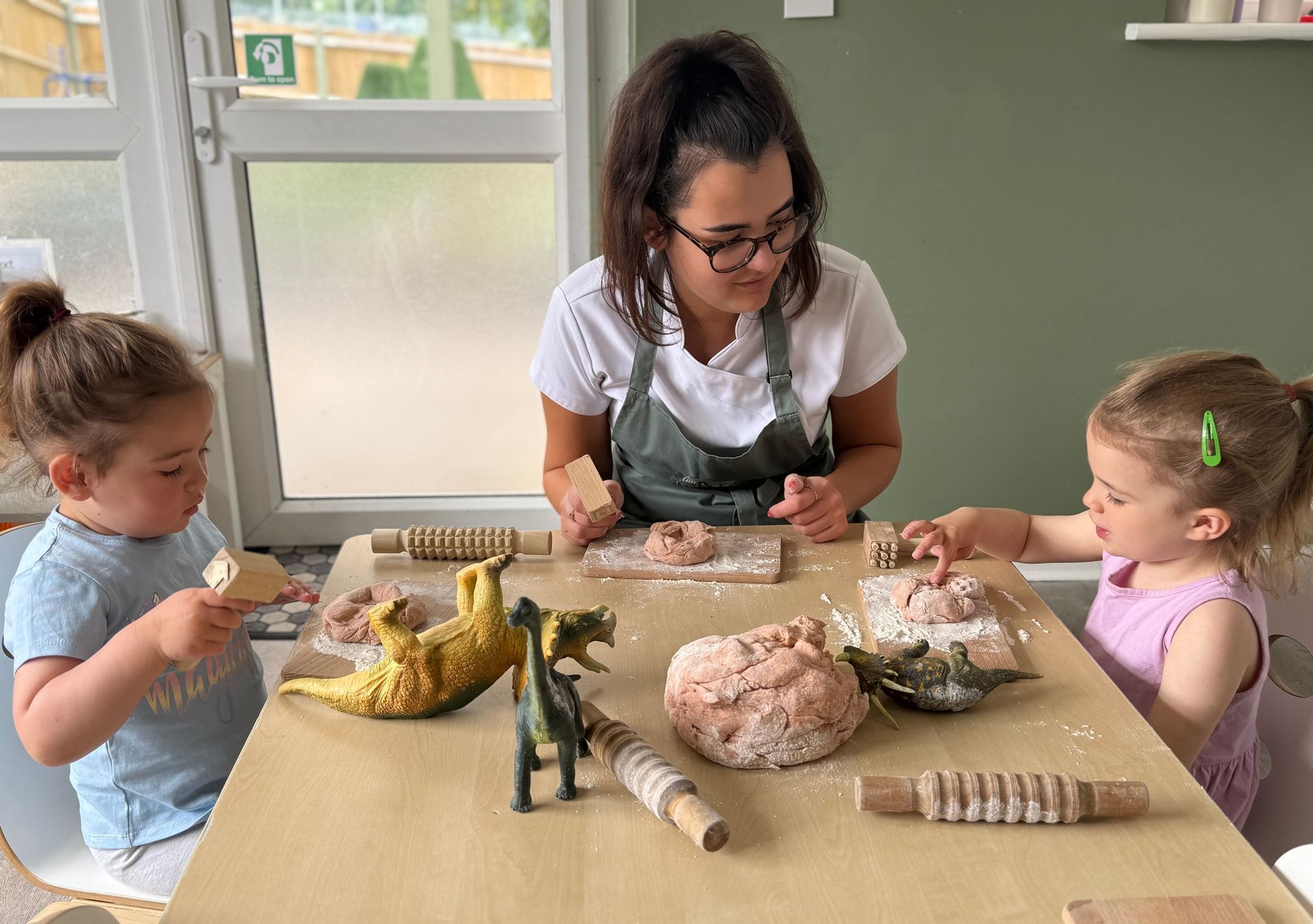 Children and Nursery Nurse participating in a natural playdough activity