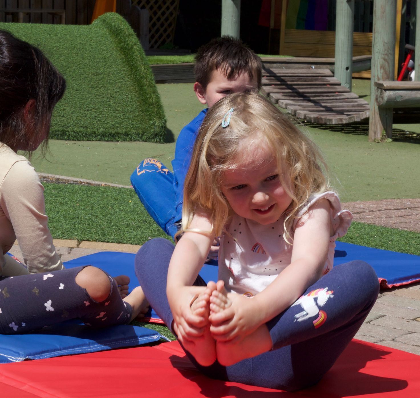 Child enjoying yoga extra curricular activity outside