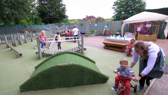 Children enjoying our large nursery garden in Ottershaw. 