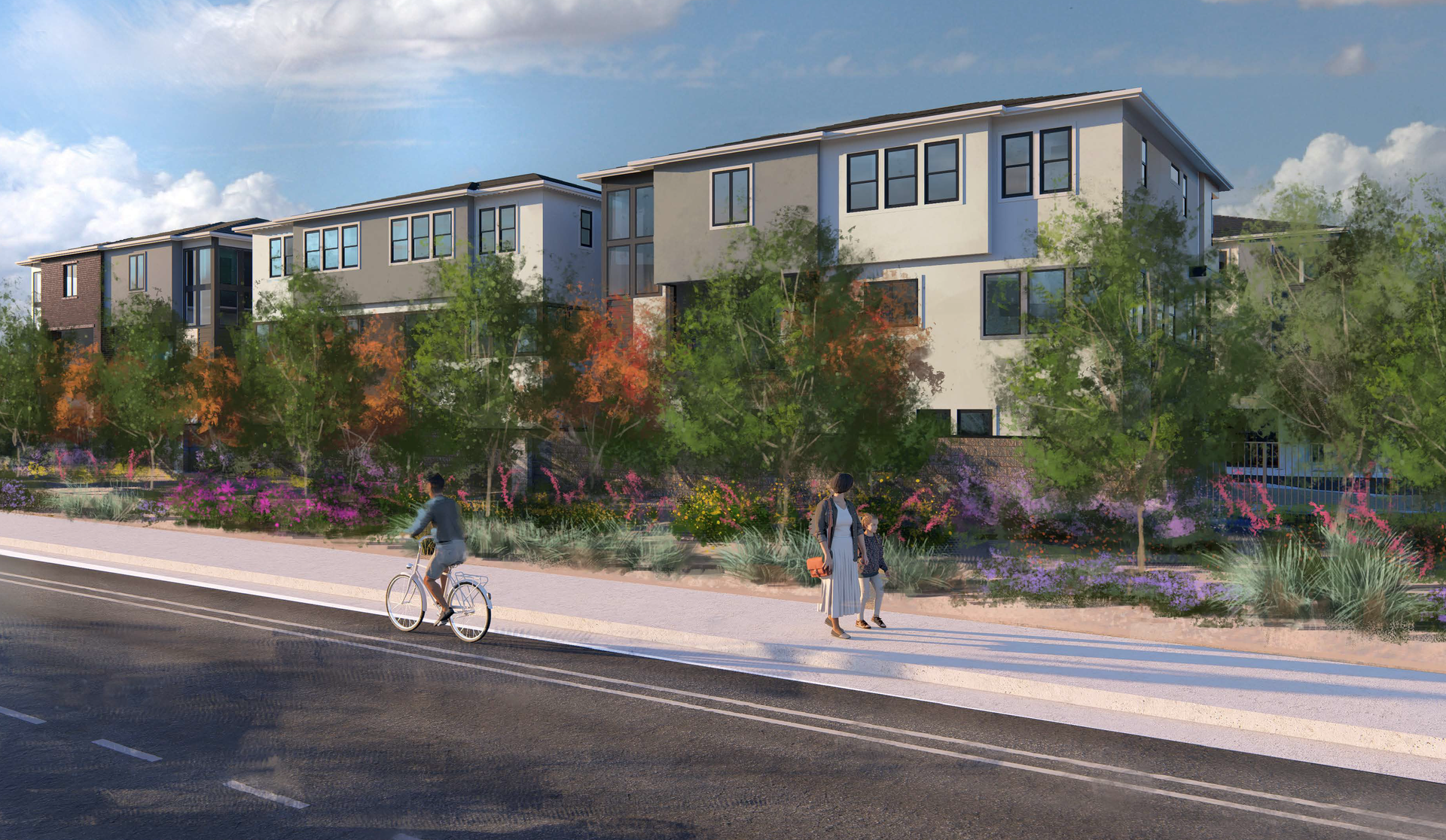 Modern apartment buildings behind a landscaped sidewalk, with two pedestrians and a cyclist on a sunny street.