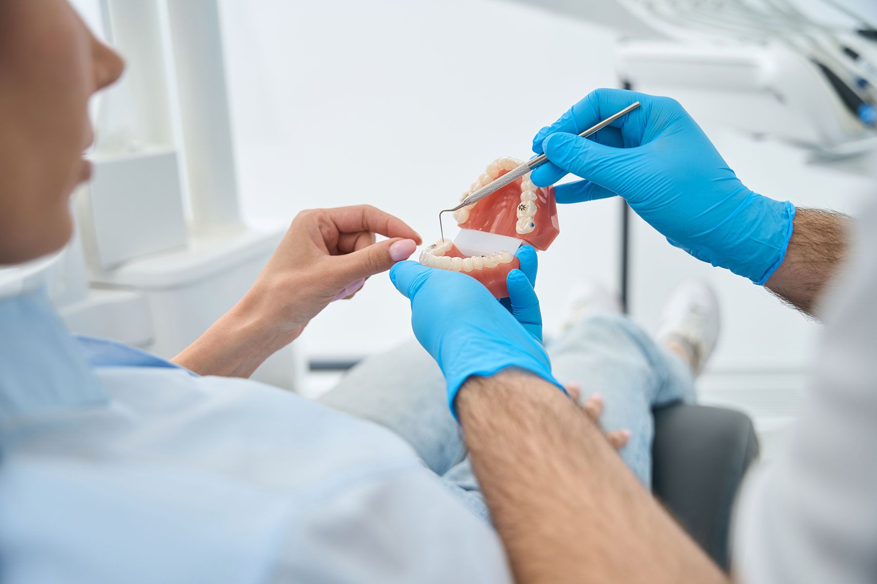 A Dentist Is Examining A Patient 's Teeth For Implant In A Dental Office — Dentist On Tweed in Tweed Heads, NSW