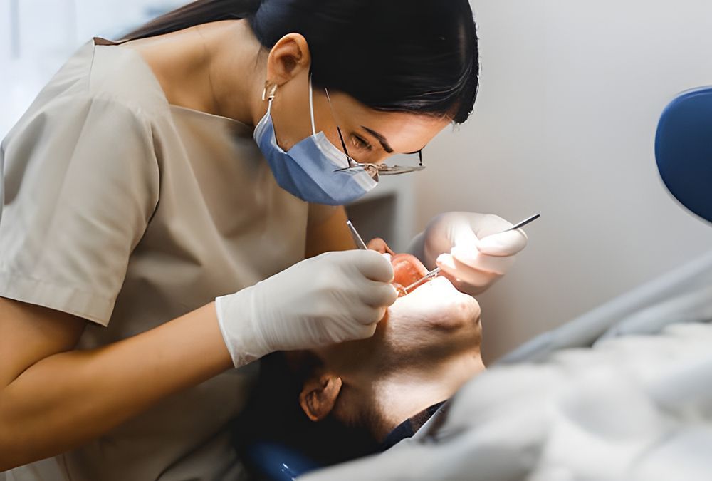 A Female Dentist is Examining a Man's Teeth in a Dental Office — Dentist On Tweed in Tweed Heads, NSW