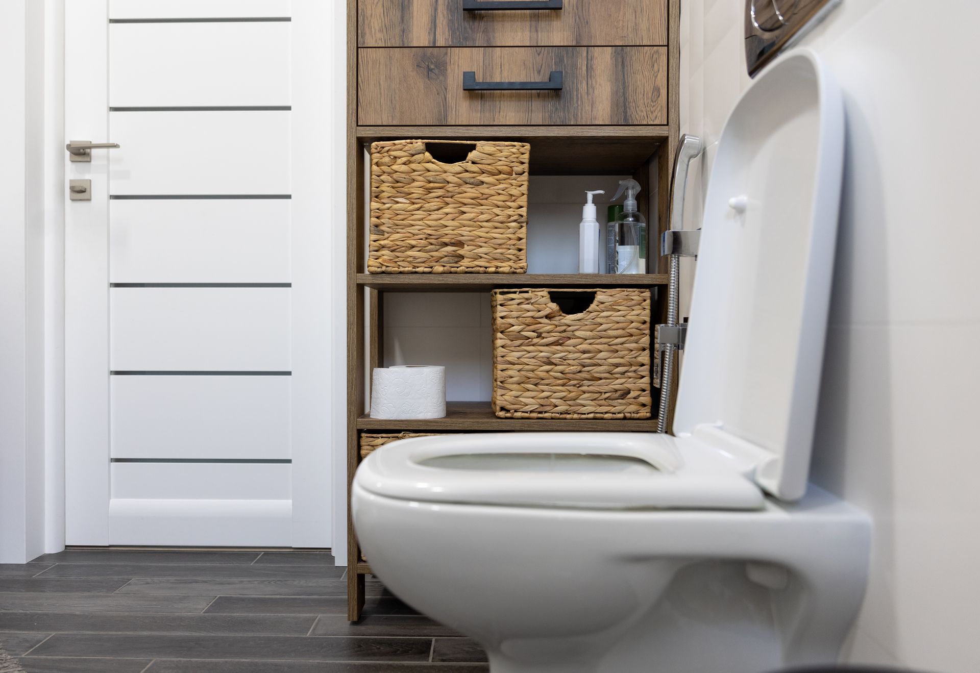 A bathroom with a toilet , sink , and shower.