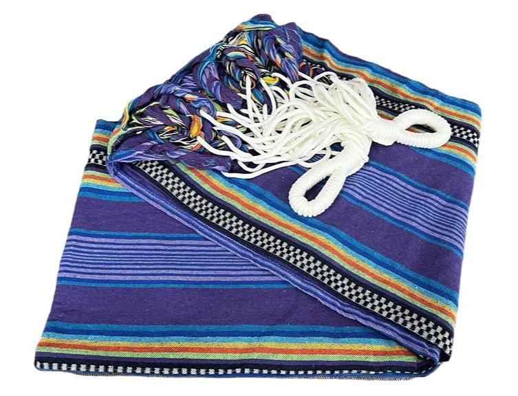 Una hamaca plegada de tonos azules con coloridos estampados de rayas