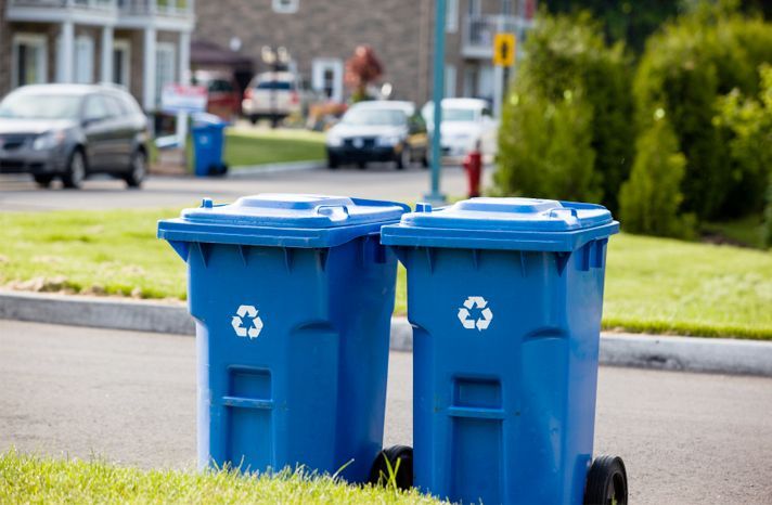 blue residential trash bins on curb in Connecticut