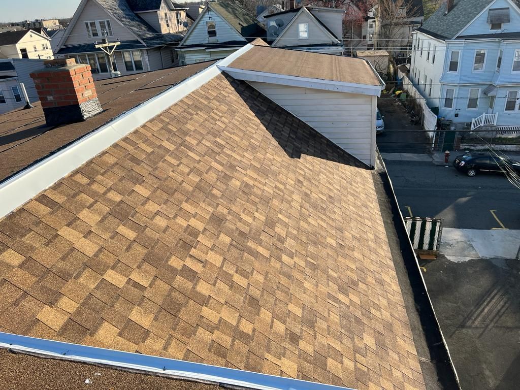 An aerial view of a roof of a house in a residential area.