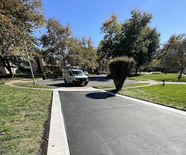 A white truck is parked on the side of a road.