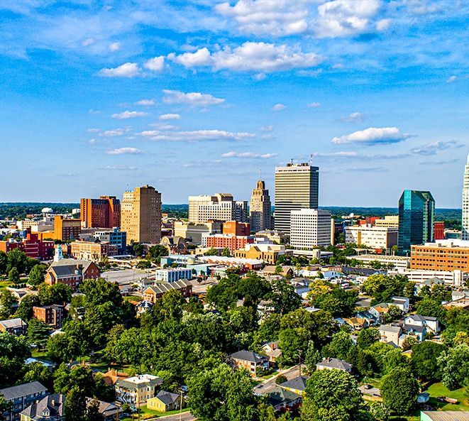 An aerial view of a city with lots of buildings and trees.