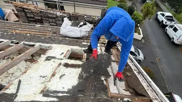 D&R Roofing specialist removing old roofing materials in Wimbledon.