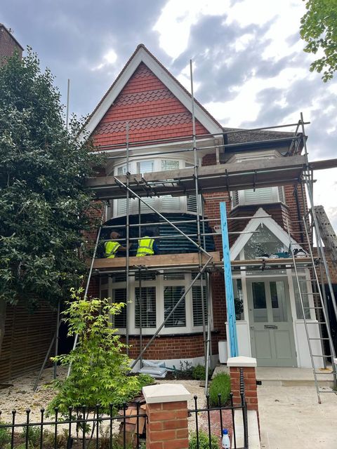 Exterior renovation by D&R Roofing in Wimbledon, showing roof and window work.