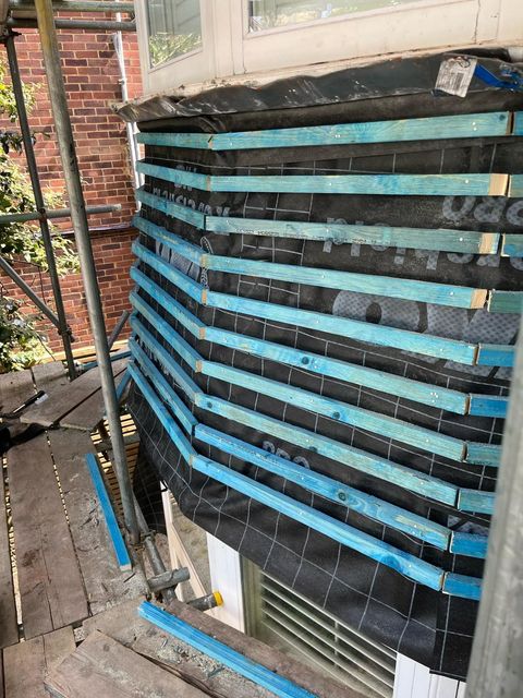 Roofer in Wimbledon installing treated timber battens.
