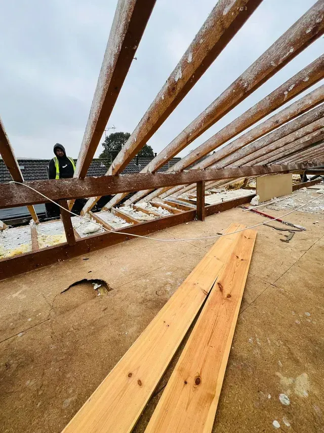 Residential roof renovation by D&R Roofing showing stripped roof and new timbers.