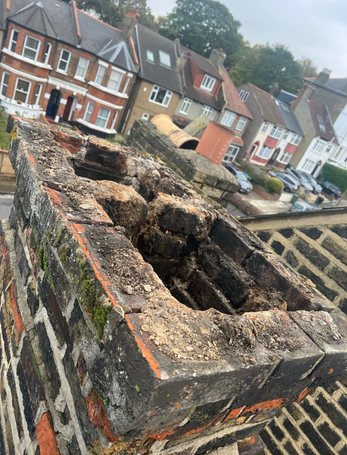 D&R Roofing inspecting a crumbling chimney stack in Wimbledon.
