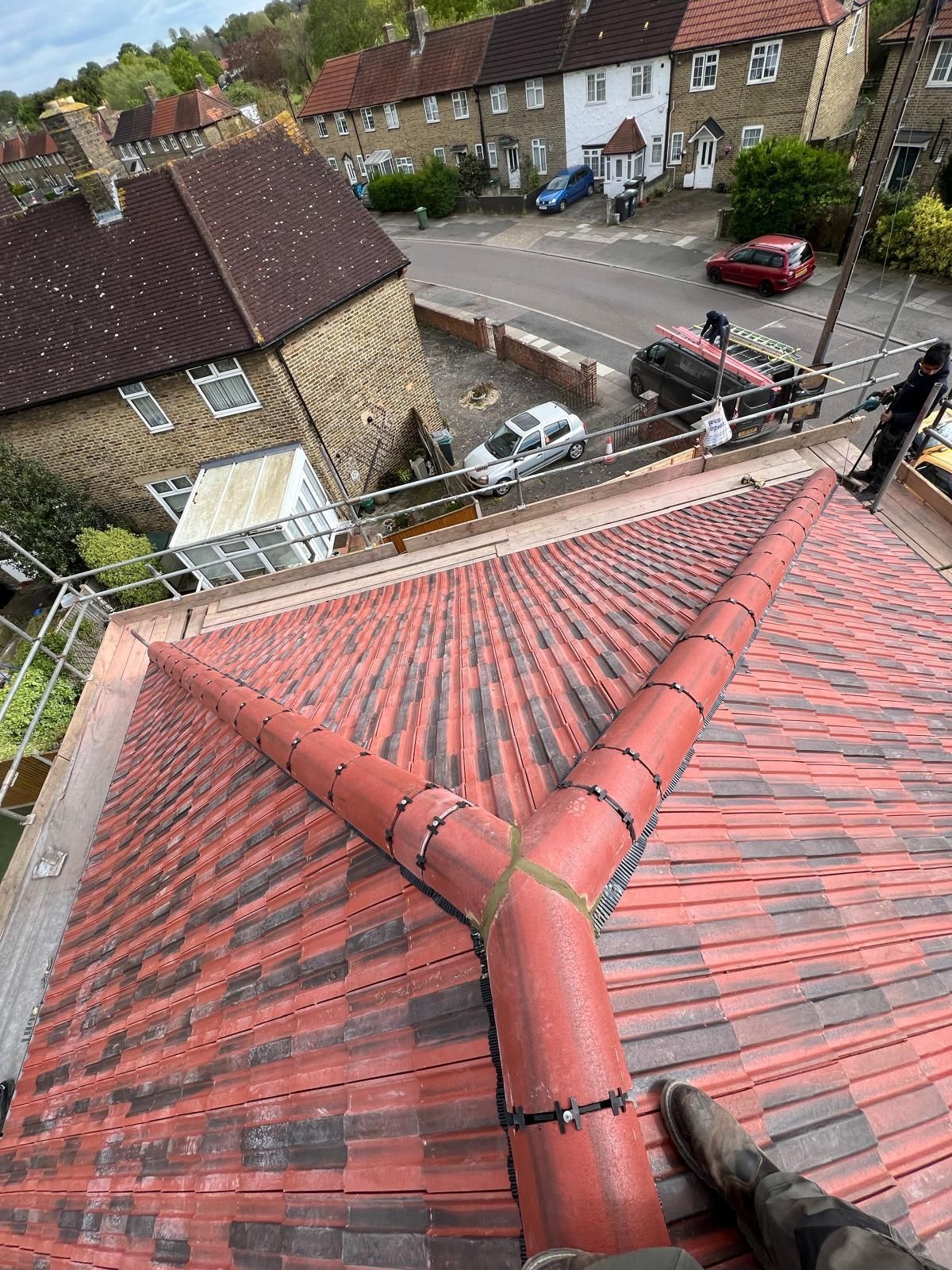 Red tiled roof replacement by a roofer in Wimbledon.