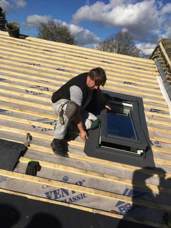Roofer in Wimbledon installing a new roof window.