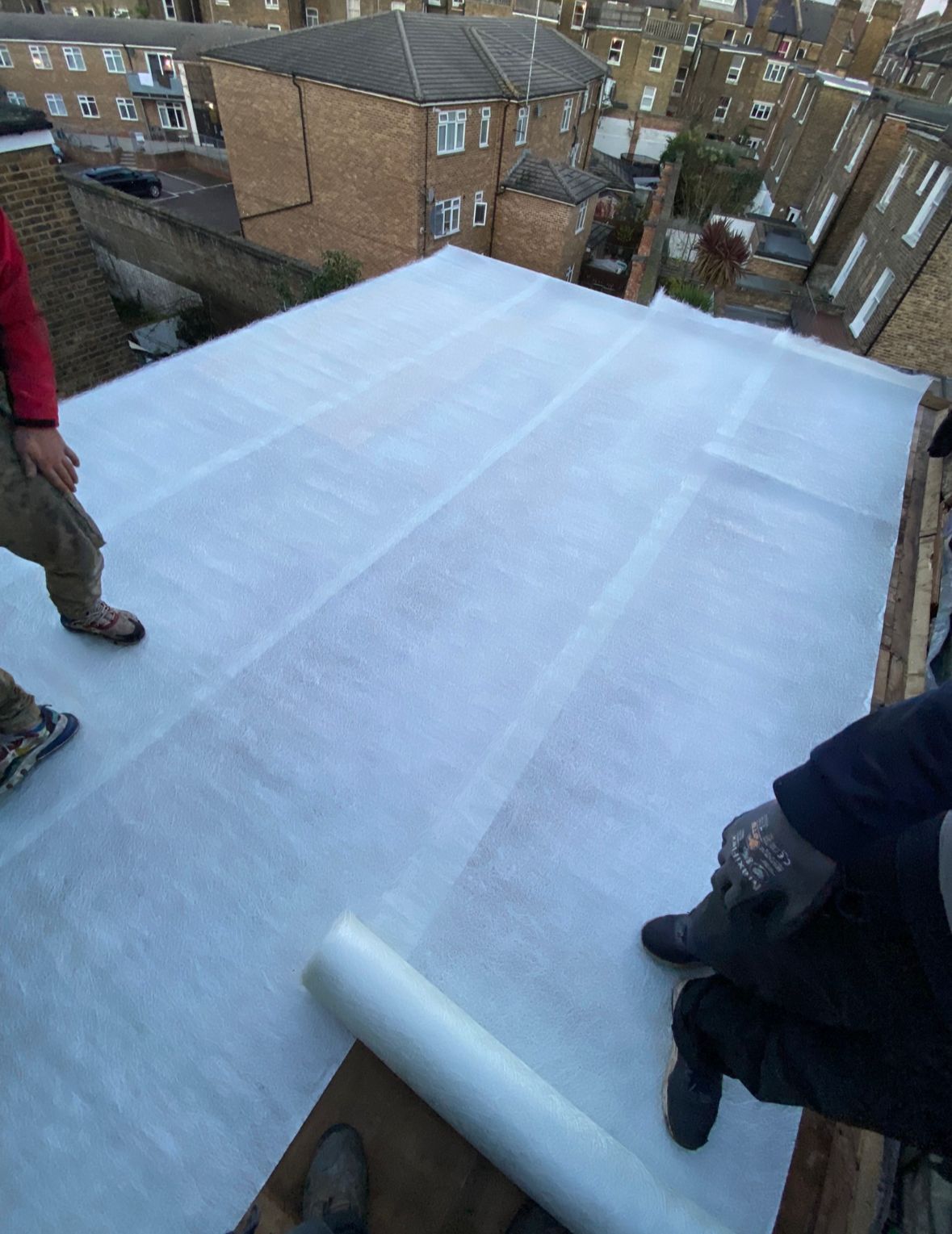 New flat roof underlay being installed by a roofer in Wimbledon.