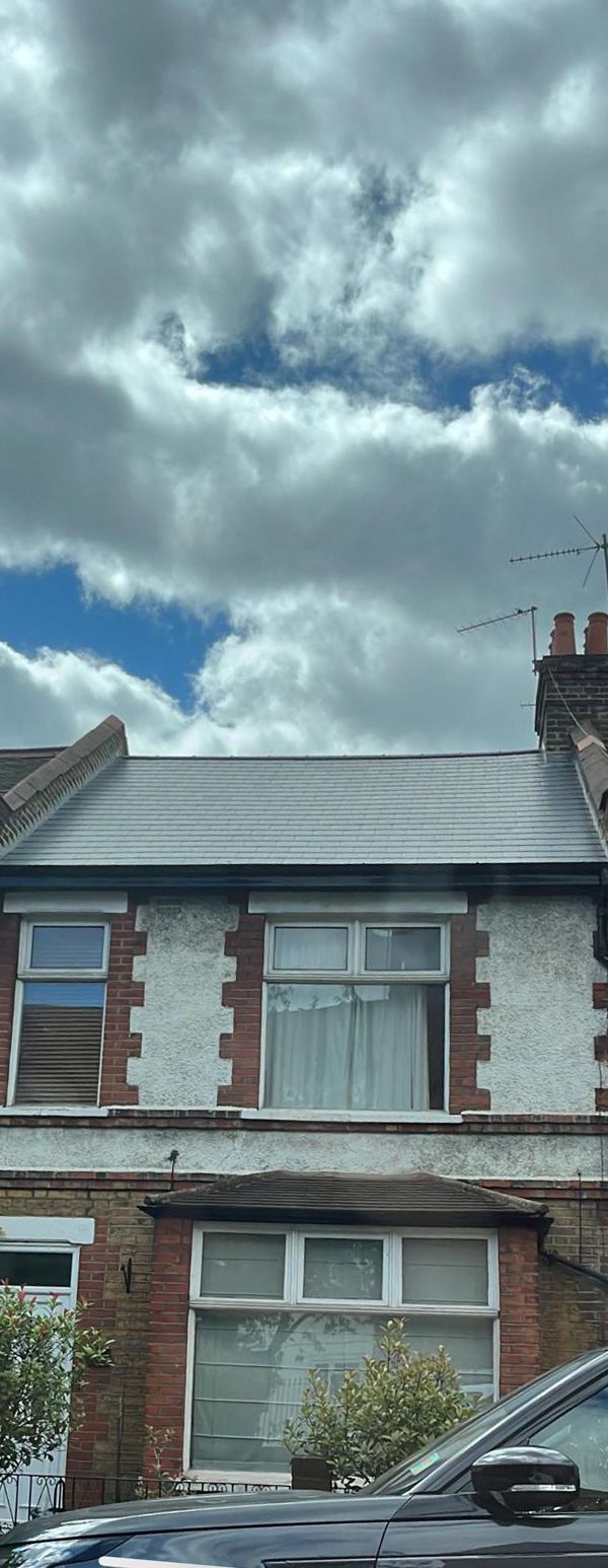 Newly replaced grey tiled roof by a roofer in Wimbledon.