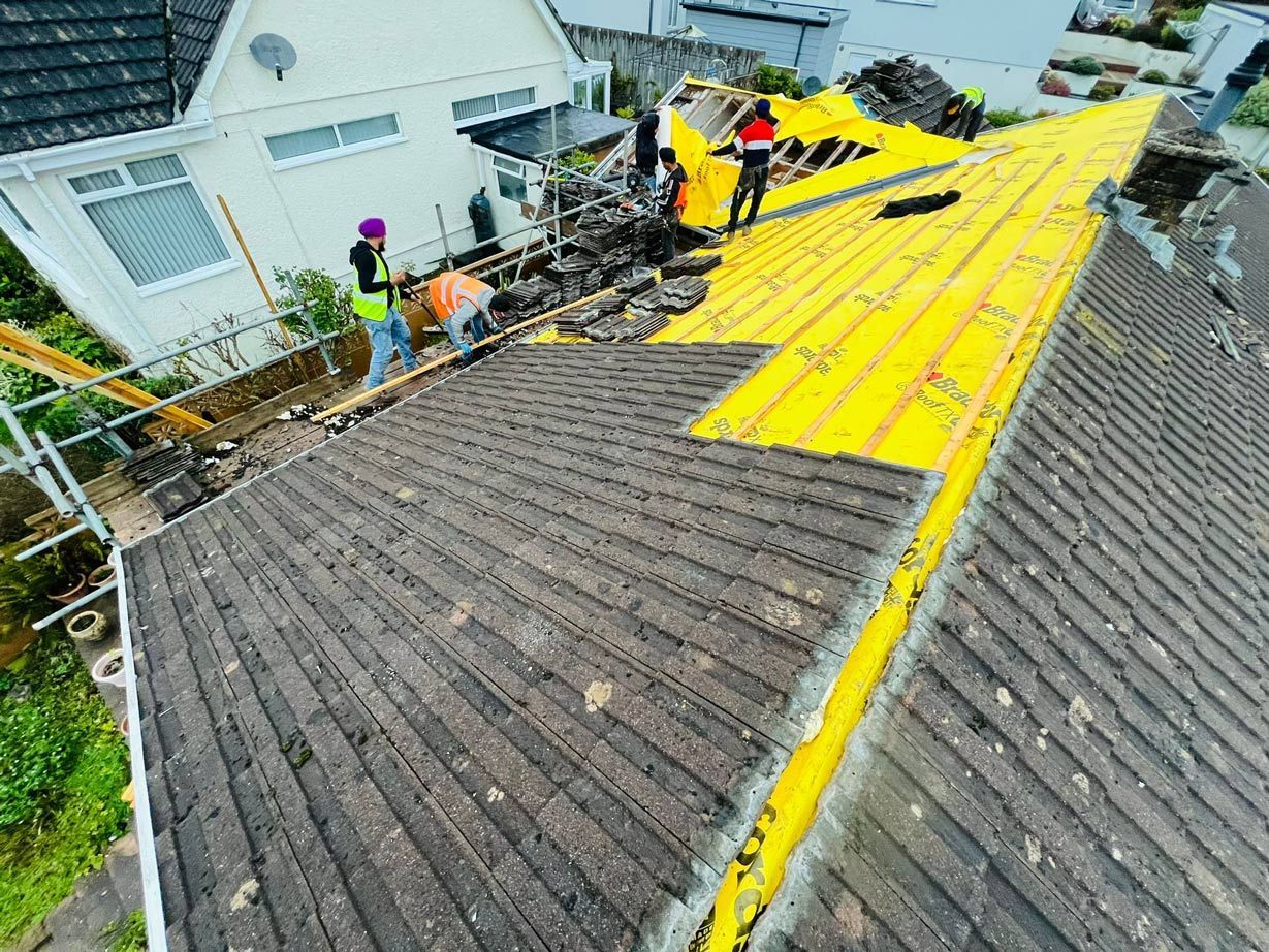 D&R Roofing team, roofers in Wimbledon working on a large residential roof renovation.