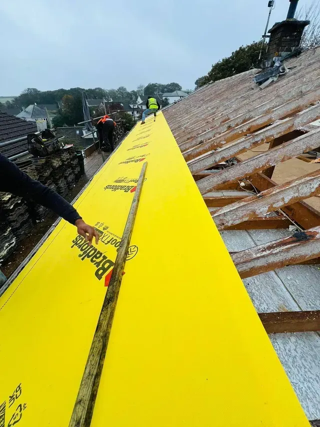 Roofers in Wimbledon installing Bradfords roof membrane on a pitched roof.