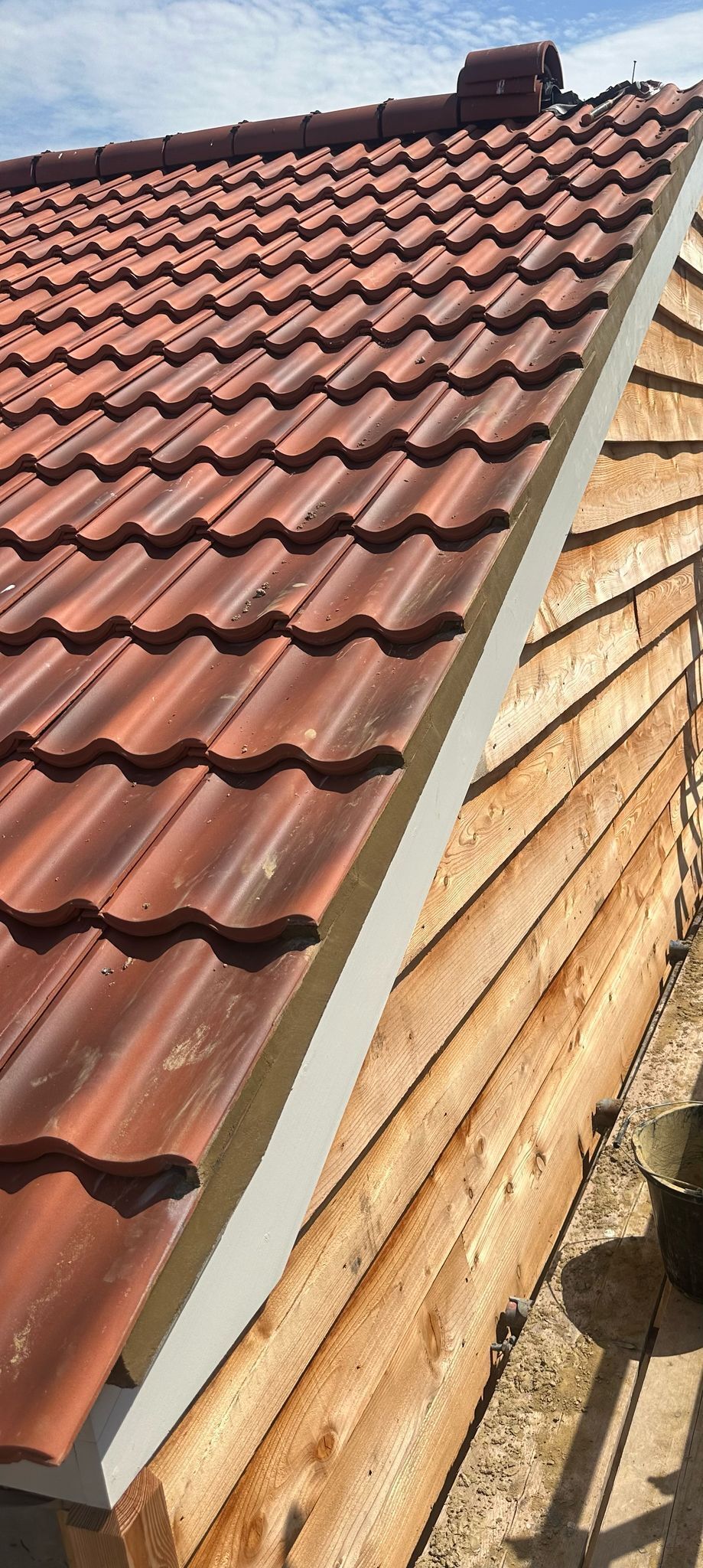 A group of people are working on the roof of a house.