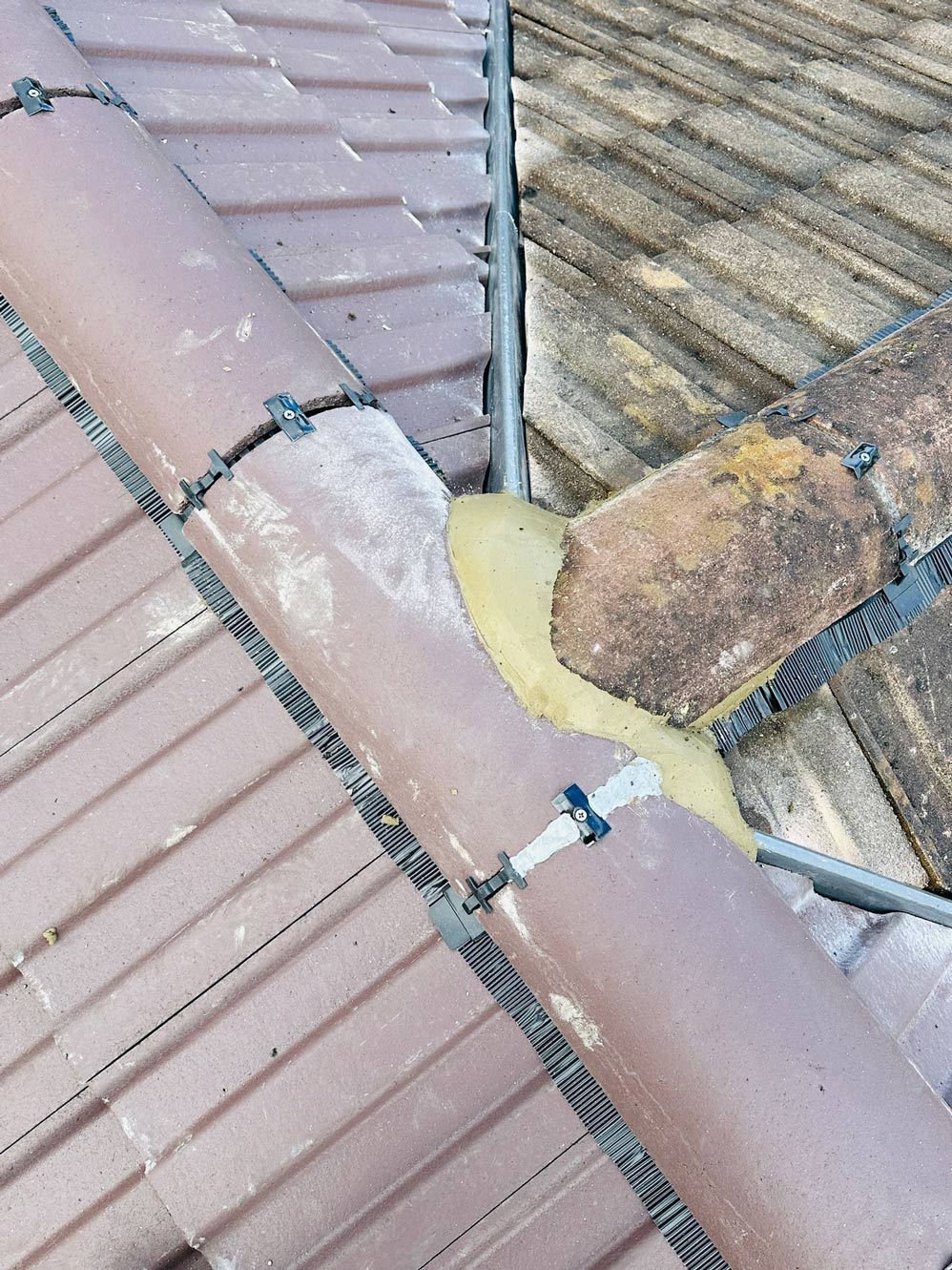 Wimbledon roofer's detail work on blending roof sections and valleys.
