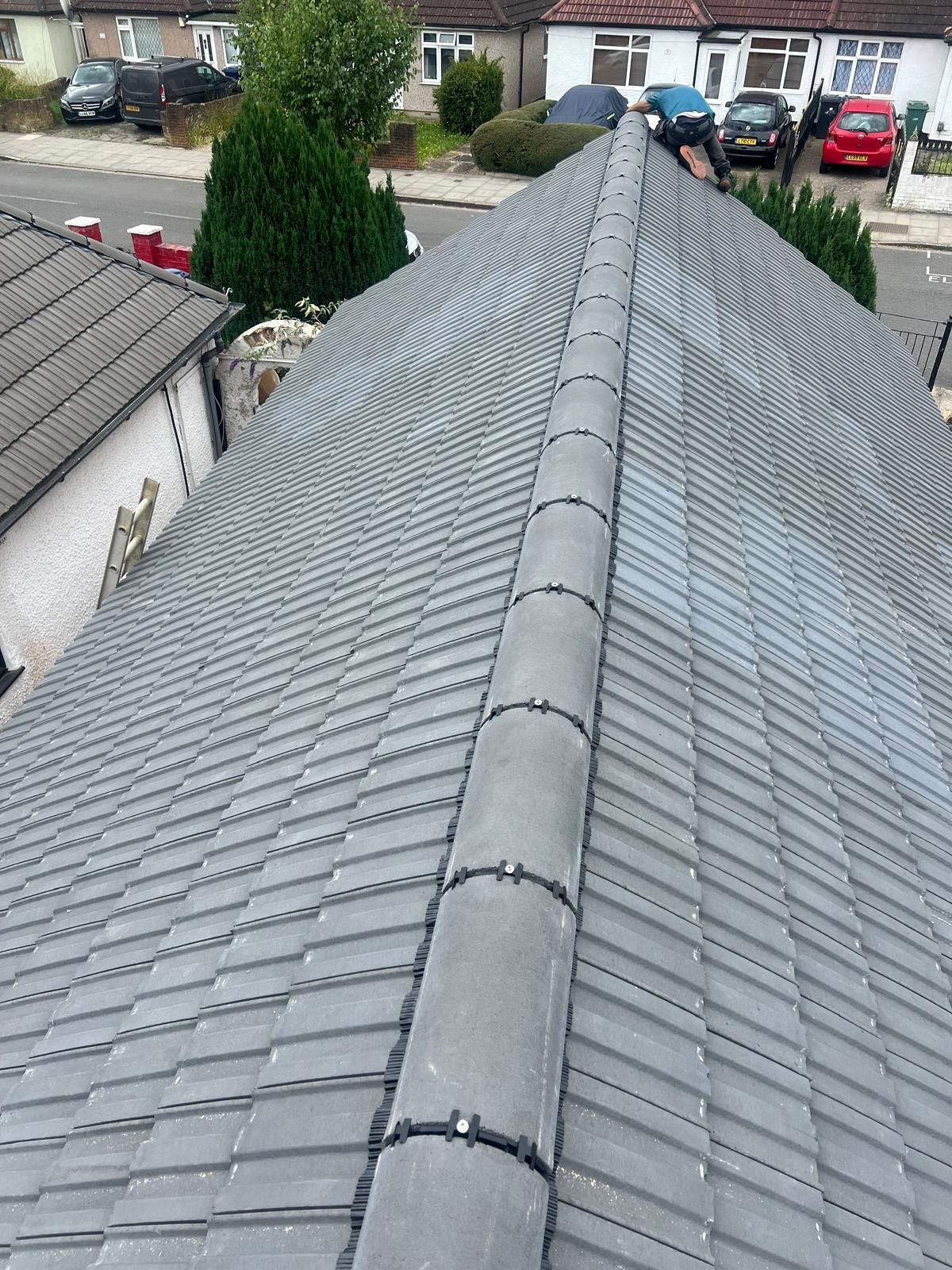 Wimbledon roofer: completed residential roof with new ridge tiles.