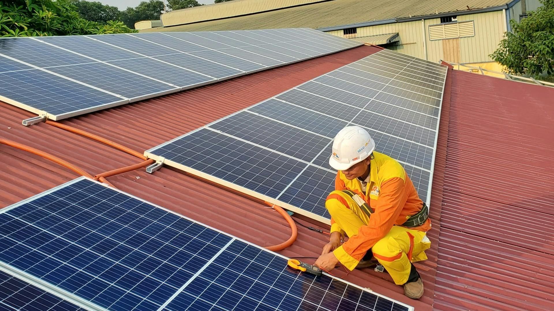 Solar panel installation and maintenance by a roofing professional.