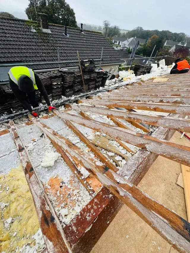 Roofer in Wimbledon working on roof insulation and repairs.