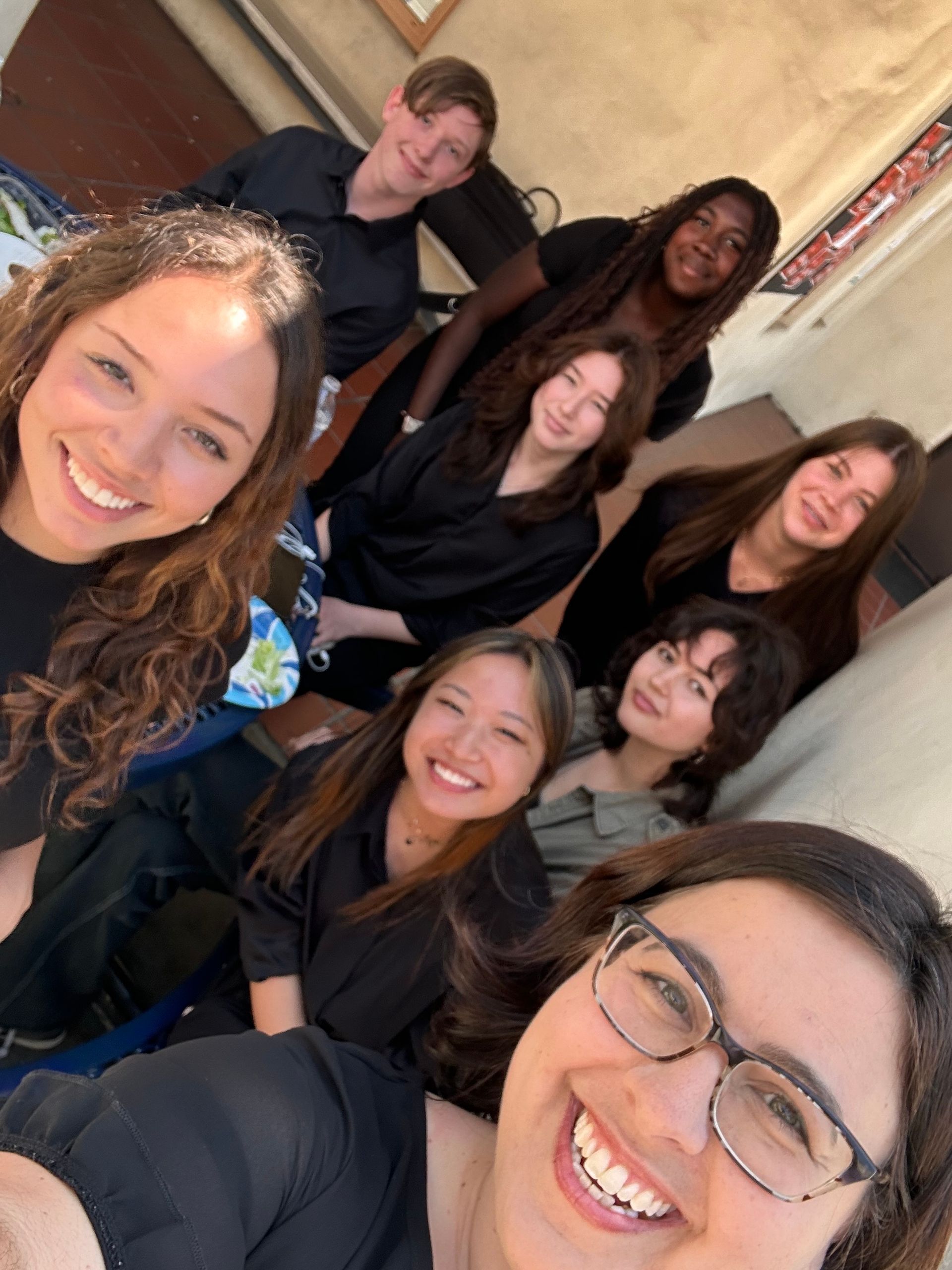 A group of people are posing for a picture together and smiling.