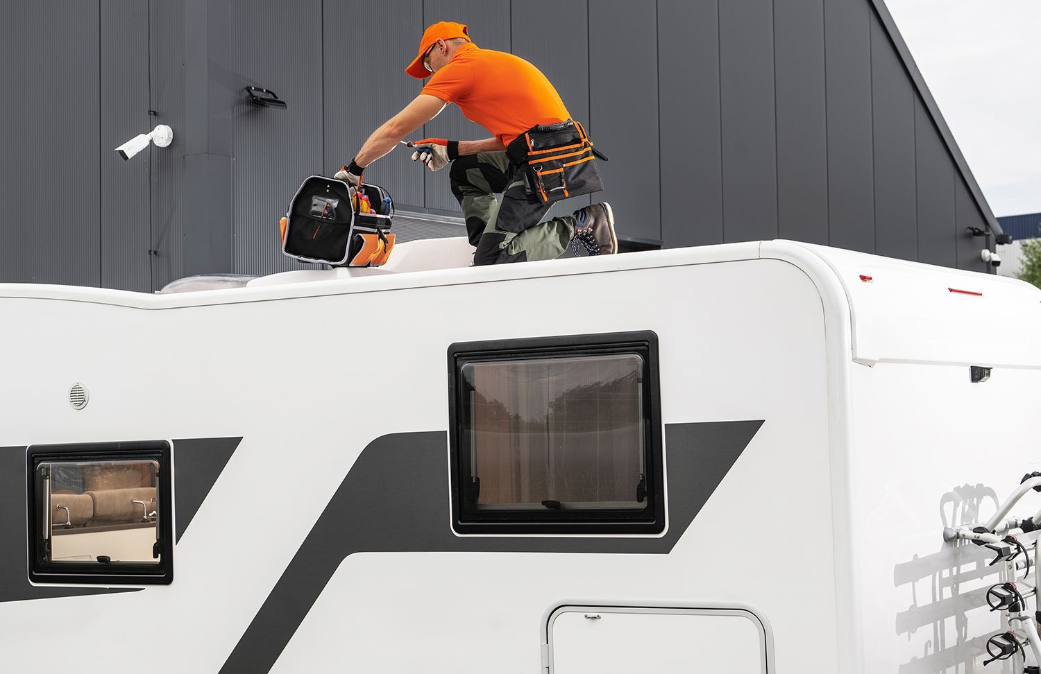 Skilled specialist with tool bag completing a routine motor home repair and inspection.