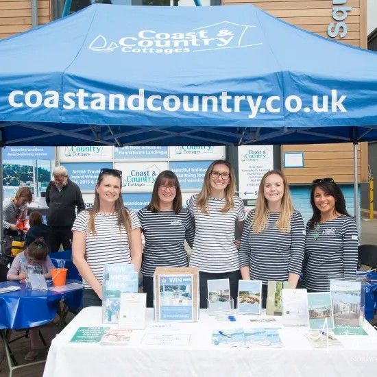 Five people in striped shirts behind a 