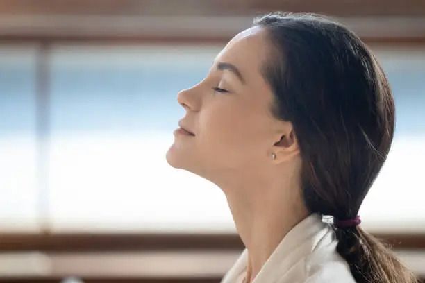A close up of a woman 's face with her eyes closed.