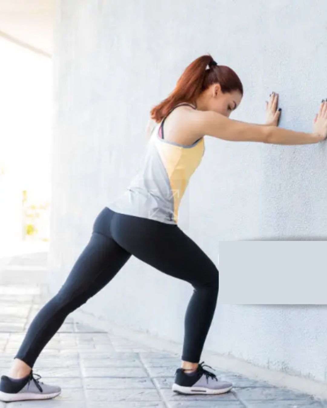women pushing wall 