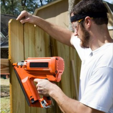 Fence contractor installing wood privacy fence.