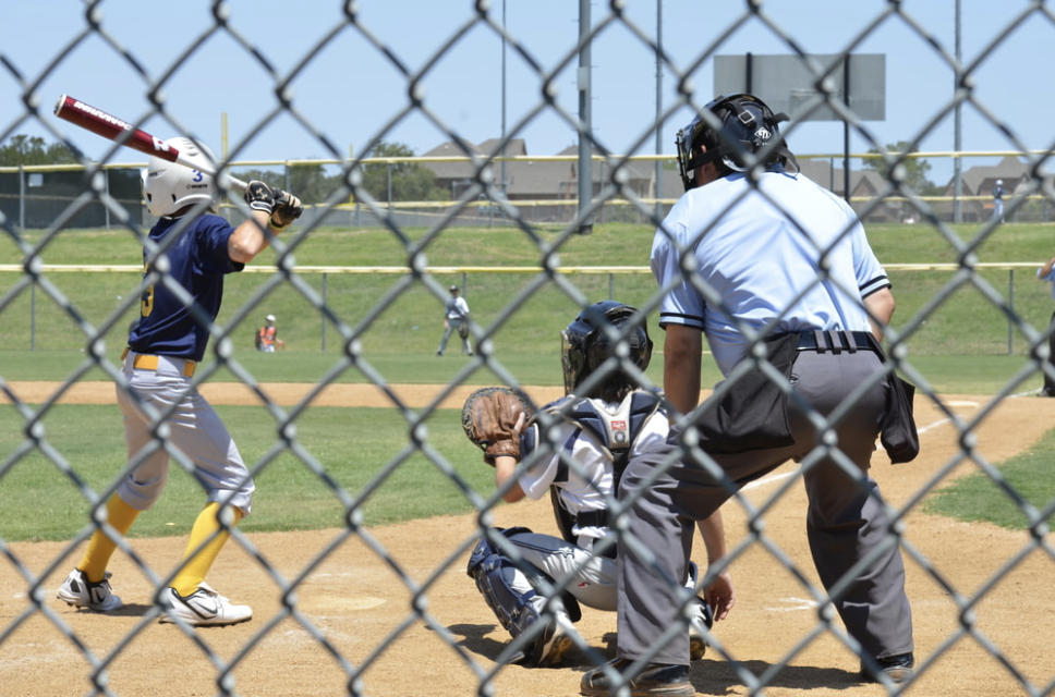 Chain link fencing surrounding baseball fields at local athletic park.