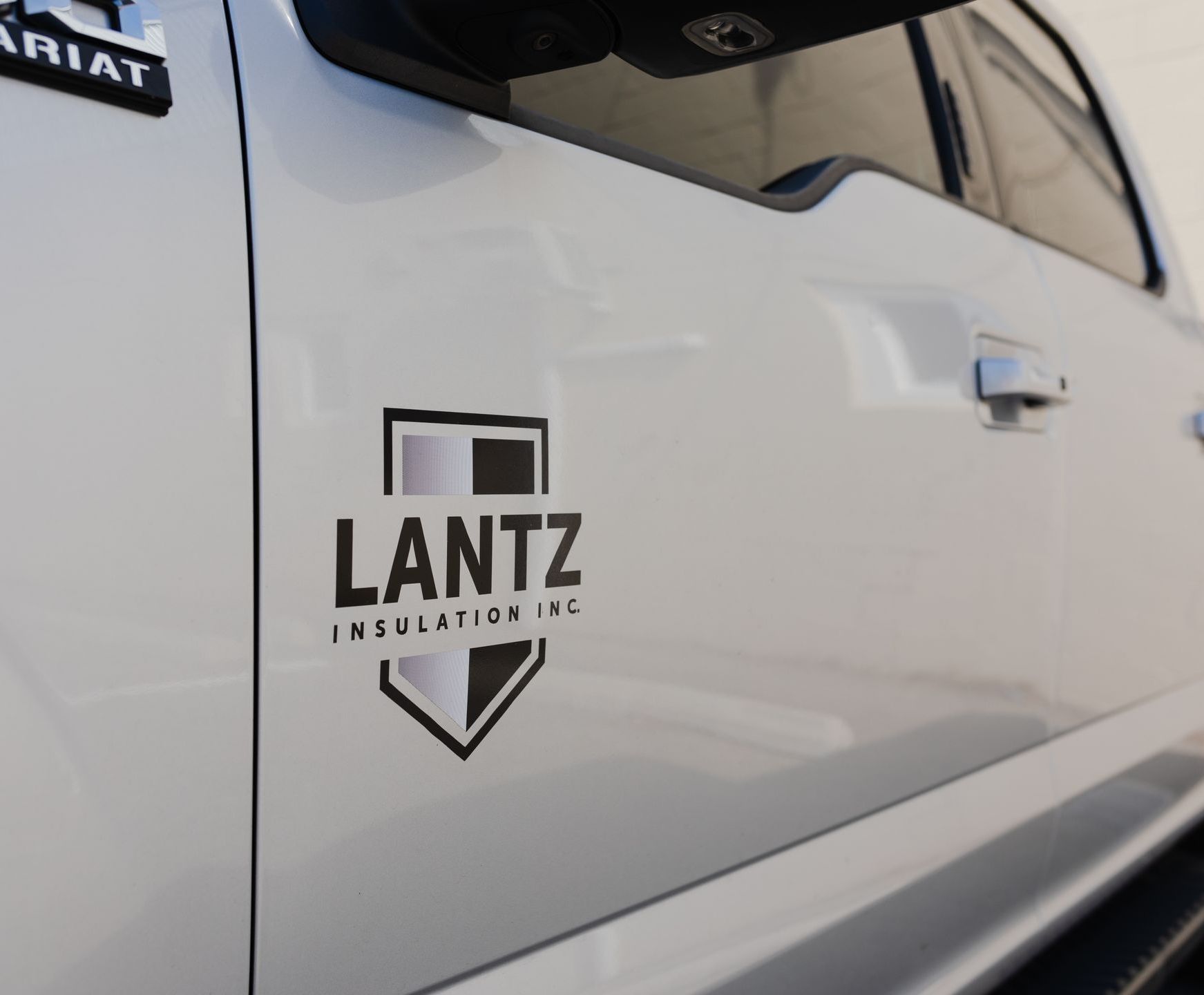 A white truck with the word lantz on the side A white truck with the word lantz on the side