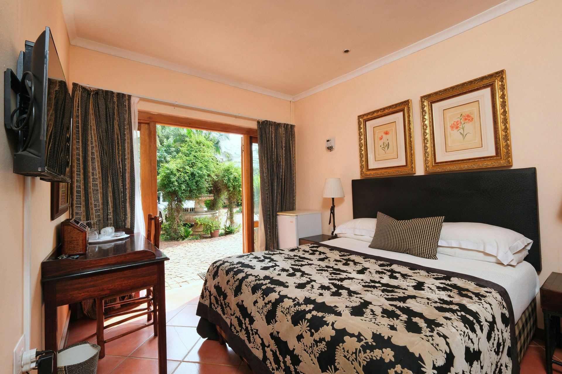 A hotel room with a large bed and a sliding glass door