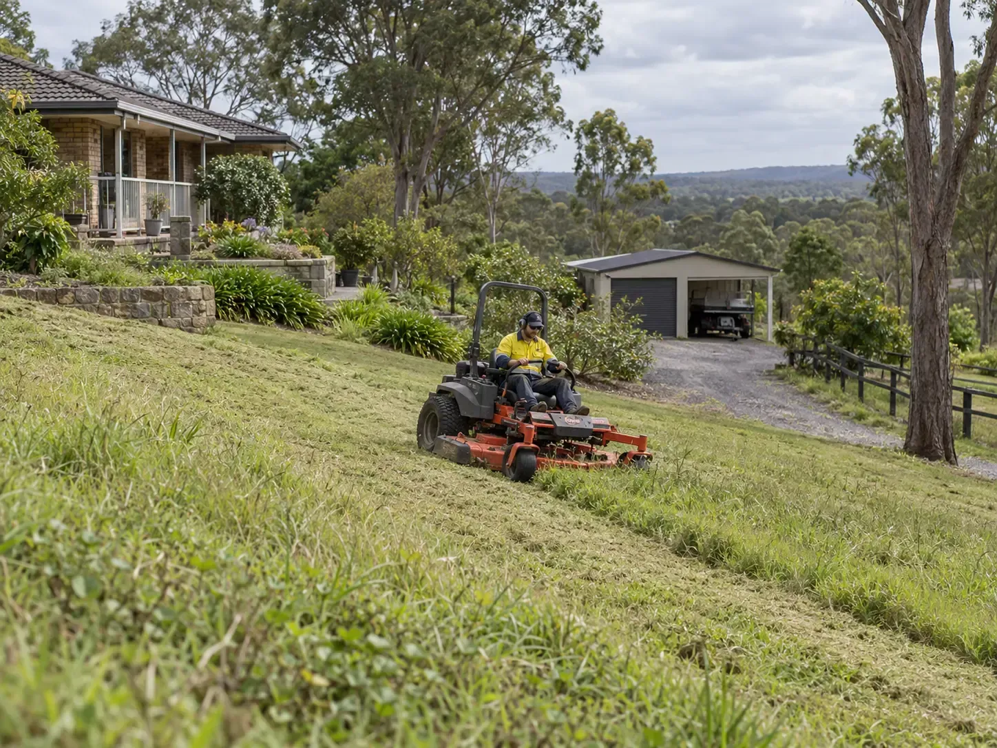Using a smaller ride-on slasher for this sloping block in Bohle Plains, Townsville.
