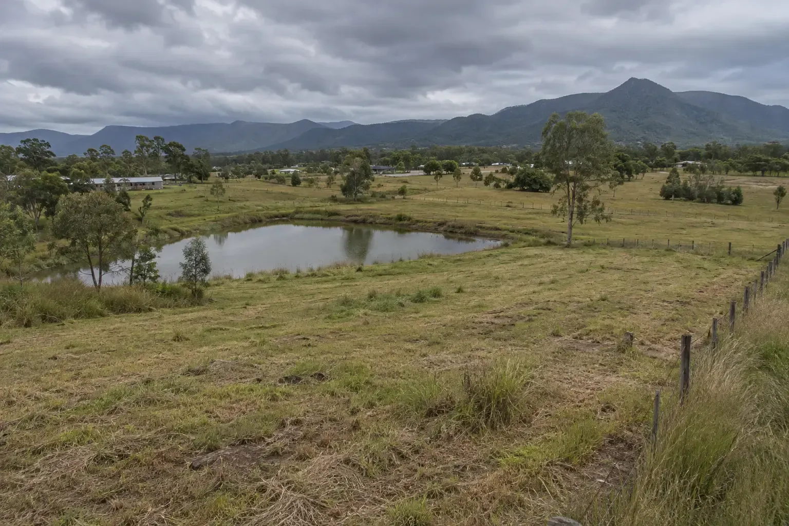 Rural dam at the bottom of a sloping bank in Bluewater, north of Townsville.