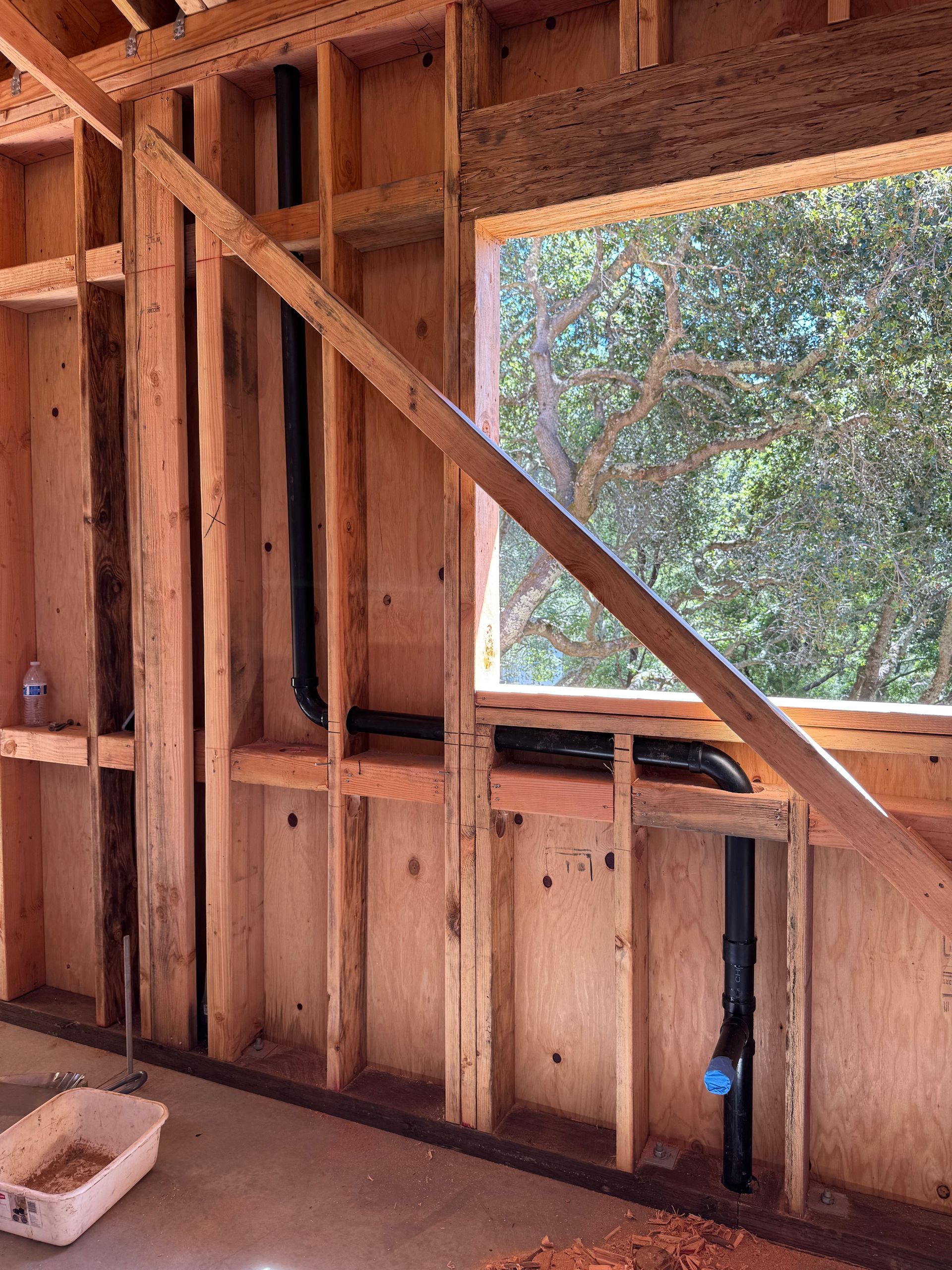 A room in a house under construction with a window.
