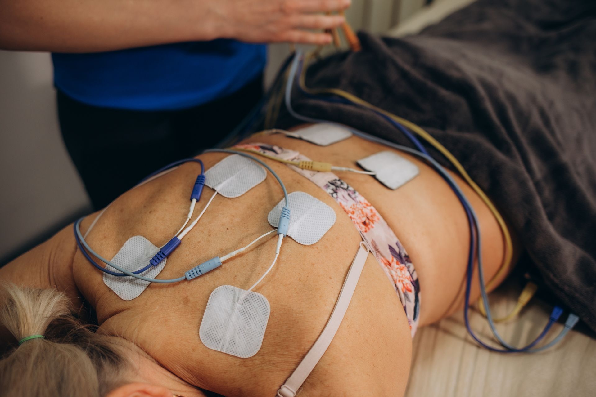 A person in CA, using a device for heart measurement at Pain Clinics of Central CA, focusing on EMG 