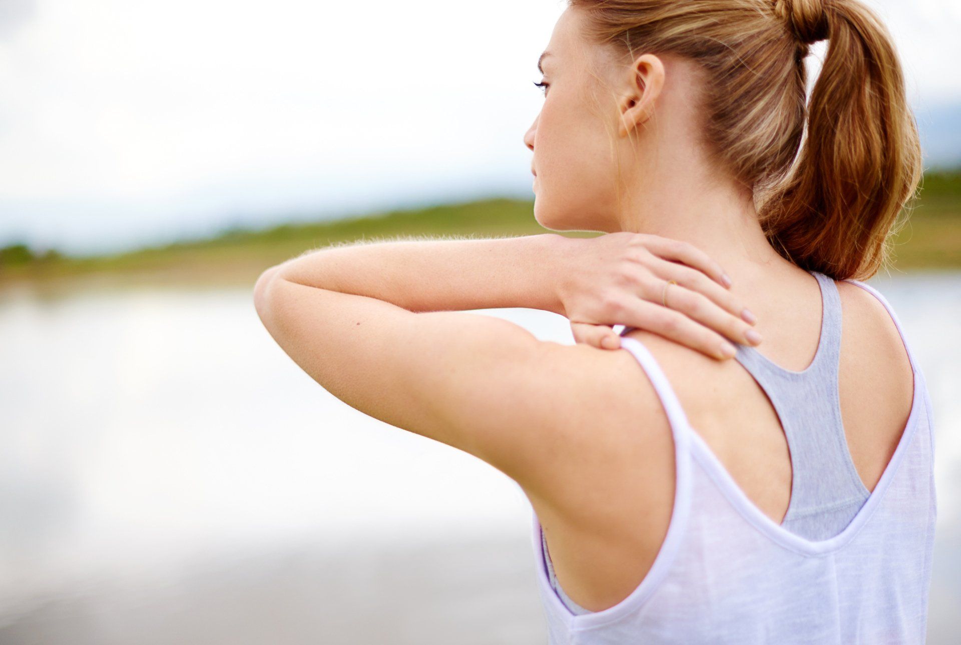 Close up of manual worker holding his back in pain, who requires pain management services. Close up of manual worker holding his back in pain, who requires pain management services.