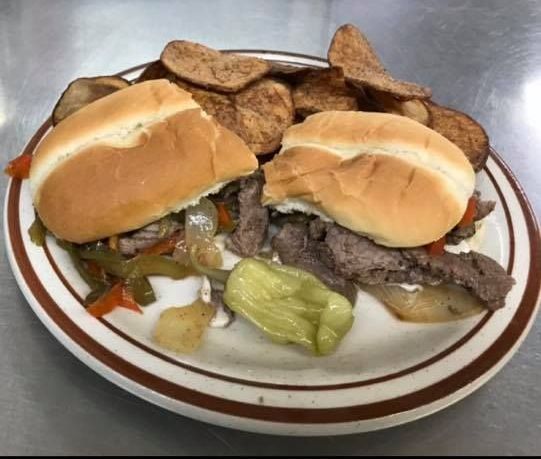 A plate of food with a sandwich and potato chips on it