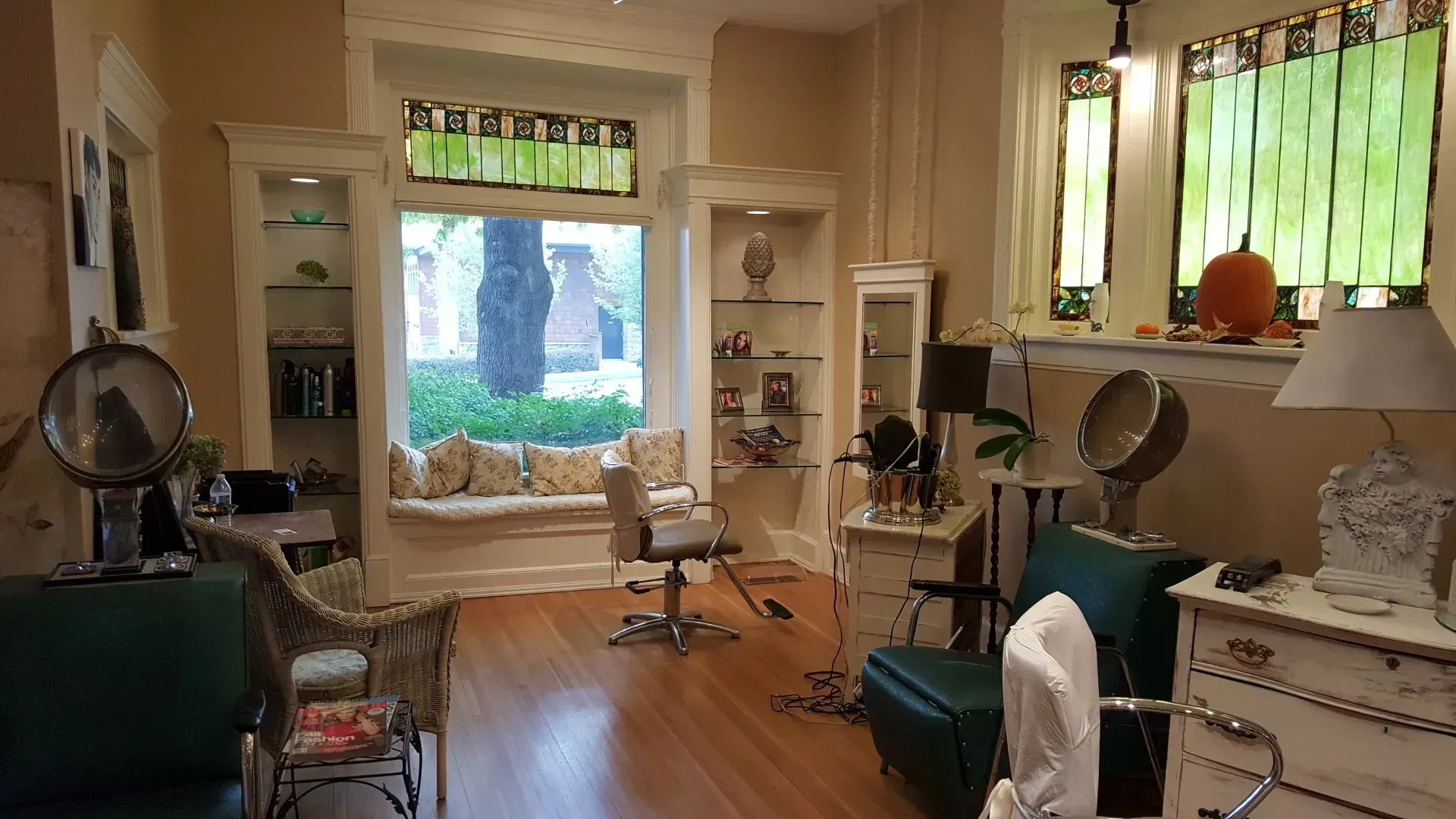 A salon with a lot of furniture and a window.