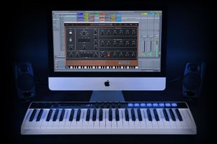 Controllers Keyboard setup: Apple monitor, keyboard controller, speakers, music software interface displayed.