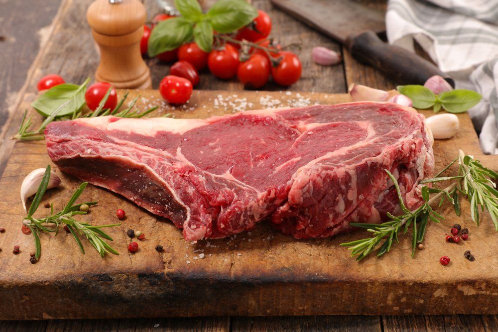 Raw Beef Chop With Ingredient on Wooden Background — Byron Bay Pork & Meats Butchery in Mullumbimby, NSW