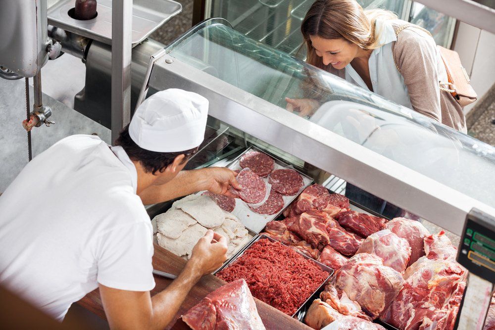 Butcher Serving Female Customer — Byron Bay Pork & Meats Butchery in Mullumbimby, NSW