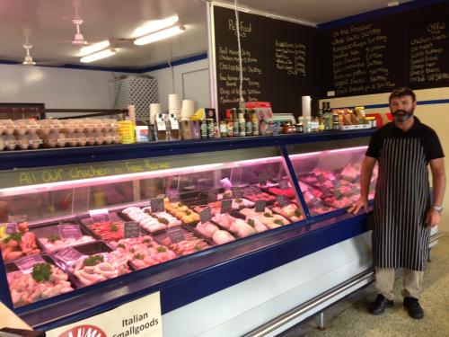Butcher Standing Beside The Meat Display — Byron Bay Pork & Meats Butchery in Mullumbimby, NSW