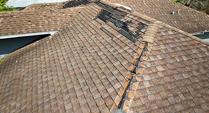 Damaged roof with missing shingles